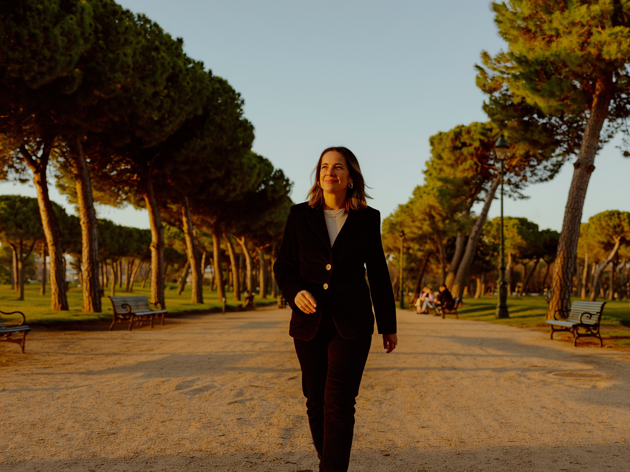 Mujer caminando con confianza por un parque europeo